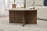 Table basse ronde avec plateau en travertin et base en bois foncé en forme de croix.